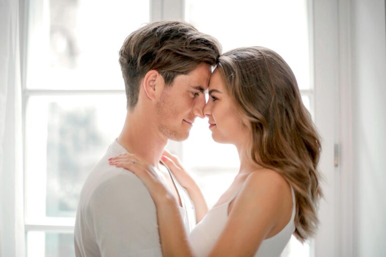 You Keep Choosing the Wrong Relationships. It Is Not Your Fault — But It Is Your Frequency. Loving couple sharing tender moment in sunlit window