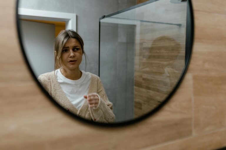 Woman gazing into mirror reflecting inner emotions self-awareness