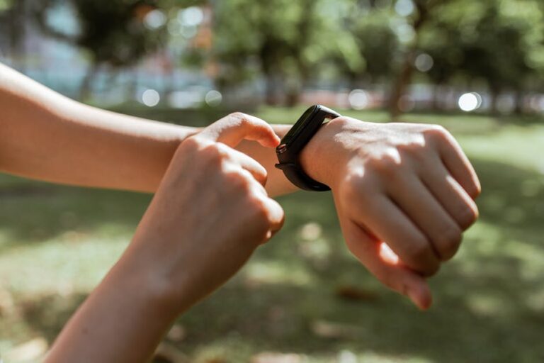 Biofeedback Is Becoming a Conversation A person holding a small wellness device while checking their body data.