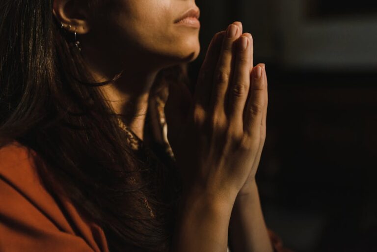 The Power of Prayer Starts With Attention A person in quiet prayer with warm sunlight around them.