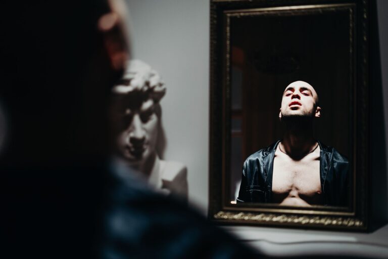 Are You a Sellout? A person looking into a mirror in a quiet moment of self-reflection.