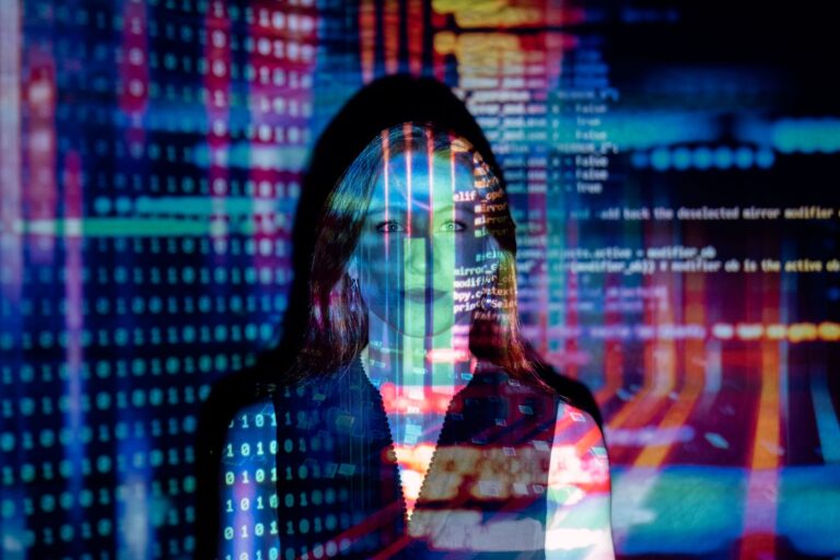 Is Your AI Use Making You Dumber or Smarter? A woman with digital code projected across her face, suggesting thought, technology, and AI mediation.